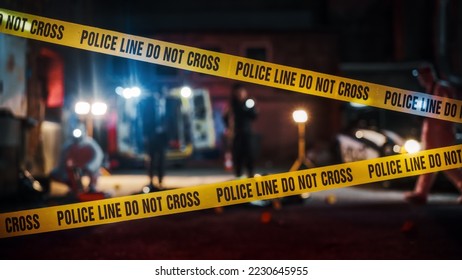 Crime Scene at Night: Crime Scene Investigation Team Working on a Murder. Female Police Officer Briefing Detective on the Victim's Body. Forensics and Paramedics Working. Cinematic Shot