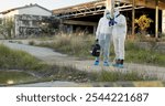 Crime scene, people and camera outdoor for forensics, evidence and investigation. CSI team, hazmat suit and check pictures in field for inspection, observation and documenting proof at police markers