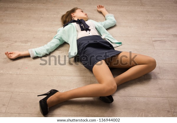 Crime scene simulation. Poisoned girl lying on the floor 