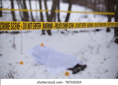 Crime Scene Tape And Dead Body Blurred In Background. 