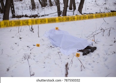 Crime Scene Tape And Dead Body Covered In Background. 