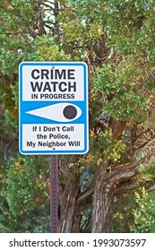 A Crime Watch Sign Is Positioned At The Entrance To A Residential Neighborhood.