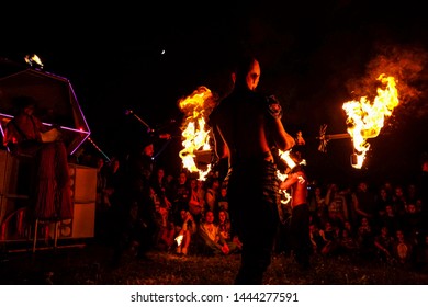 Crimea, Russia - June 2019: a group of clowns and jugglers show fire-show at the festival in Crimea - Shutterstock ID 1444277591