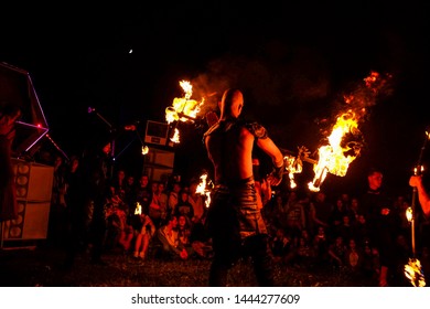 Crimea, Russia - June 2019: a group of clowns and jugglers show fire-show at the festival in Crimea - Shutterstock ID 1444277609