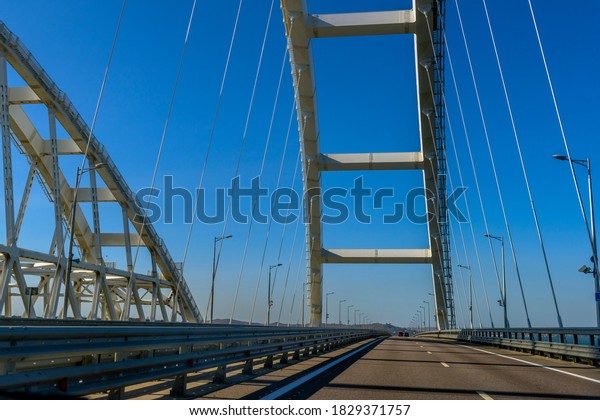 Crimean\
bridge, Taman, Russia - 11,09,2020: The navigable arch of the\
Crimean bridge. Arch of the highway and railway section of the\
Crimean bridge. Driving along the Crimean\
bridge.