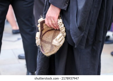 A Criminal Barrister Holding Their Wig.