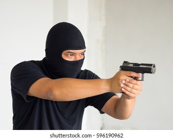 Criminal Hand Holding Short Gun Inside Building Structure, Hacker ,stealth Concept