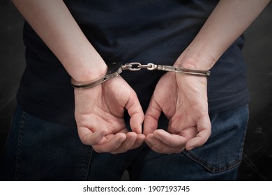 Criminal handcuffed, back view. Criminal arrested, security concept