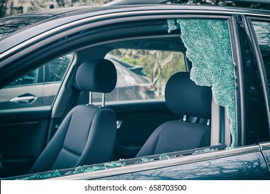 A criminal incident. Hacking the car. Broken left side window of a car
                               