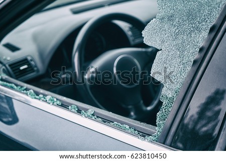 A criminal incident. Hacking the car. Broken left side window of a car
                               