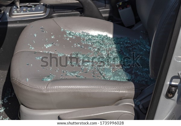 Criminal incident. Hacking a car. Broken
driver's side window of car. Thieves smashed window of car with
fragments inside, glass was scattered throughout. Crime - broken
window and theft
belongings