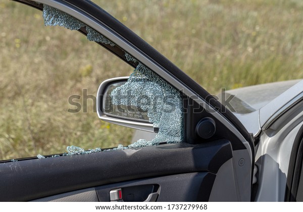 Criminal incident. Hacking a car. Broken
driver's side window of car. Thieves smashed window of car with
fragments inside, glass was scattered throughout. Crime - broken
window and theft
belongings