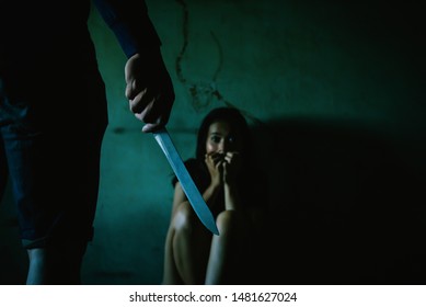 Criminal With Knife Attack Woman In Abandoned House,The Man With A Knife In A Hand,close Up,