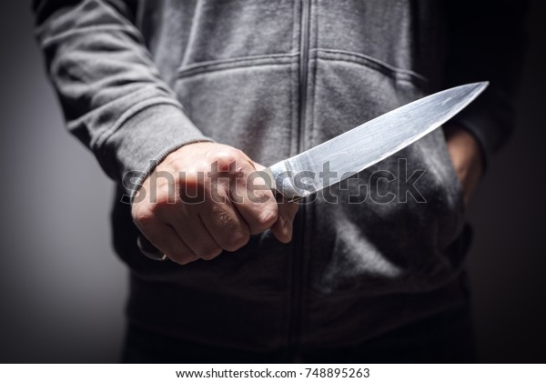 Criminal with knife\
weapon threatening to\
stab