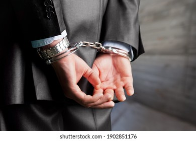 Criminal man with his hands in handcuffs