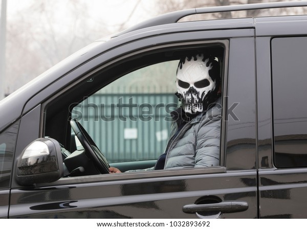 the criminal in the mask\
in the car