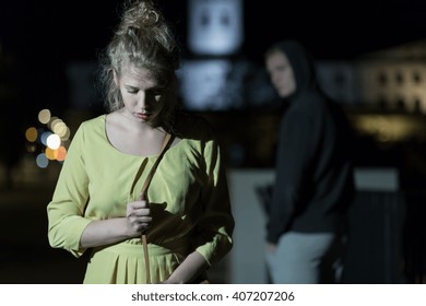 Criminal Observing Young Woman Walking Alone At Night