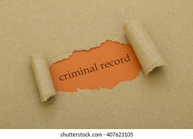 Criminal Record Written Under Torn Paper.