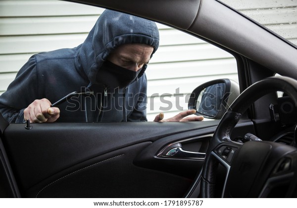 The
criminal is trying to hack the car. Car
thief.