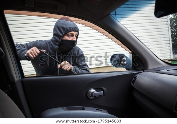 The\
criminal is trying to hack the car. Car\
thief.