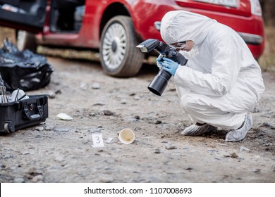 Criminological expert collecting evidence at the crime scene. Law and police concept