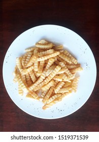 Crinkle Cut Chips Or Fries On A Plate.