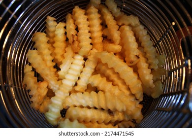 Crinkle Cut Fries In A Fryer Strainer 