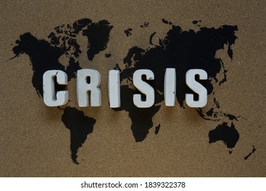 Crisis Inscription On The Cork Board With World Map Symbolizes The Global Crisis Caused By Covid-19, Novel Corona Virus