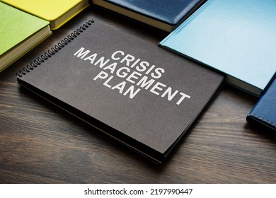 Crisis Management Plan And Notepads On The Desk.