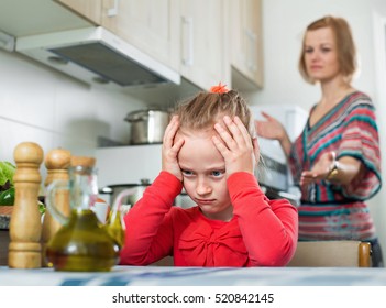 Crisis Of Motherhood: Ordinary Young Angry Woman Preaching Little Sad Daughter