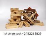 Crisis in the real estate market. Wooden houses sit among the collapsed blocks.