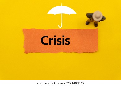 Crisis.The word is written on a slip of colored paper. Insurance terms, health care words, Life insurance terminology. business Buzzwords. - Shutterstock ID 2191493469
