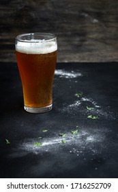 Crisp Pale Ale In Schooner Glass On A Wooden Table Whilst Cooking.