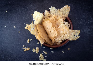 Crisp Parmesan Cheese Chips, Homemade Party Snack In A Bowl On A Dark Slate Background, High Angle View From Above, Copy Space