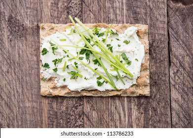 Crispbread With Creme Cheese And Chives On Wood