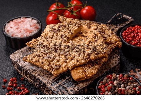 Crispbread, thin bread with seeds and grains, a baked cracker. Crispbread with pumpkin seeds and flax and sesame seeds