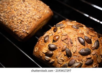 Crispy Baked Buns With Grains On An Oven Rack