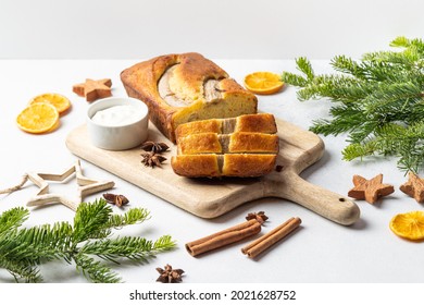 Crispy Banana Bread With Cinnamon On A Gray Concrete Background. Christmas Or New Year's Dessert. Christmas Tree Branches.