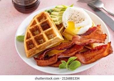 Crispy Belgian waffles with avocado, poached egg and bacon, healthy and filling breakfast - Powered by Shutterstock