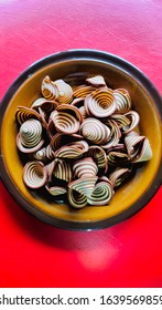 Crispy Biscuits Named Elephant Ears/ Cow Ears Or Pig Ears, Are Isolated On A Brown Plate With A Red Background