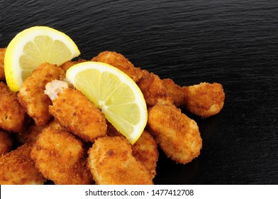 Crispy Breadcrumb Covered Fried Scampi On A Slate Background