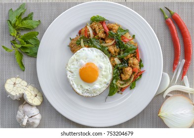 Crispy chicken cooked with sweet basil eat with rice and egg.it is a very delicious Thai food.