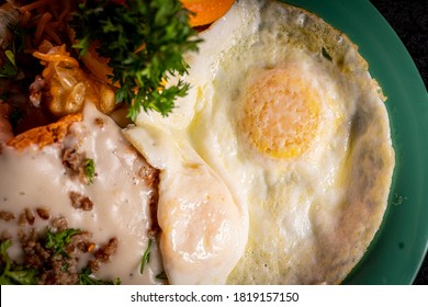 A Crispy Chicken Fried Steak With Cheesy Potatoes, Eggs And Gravy.