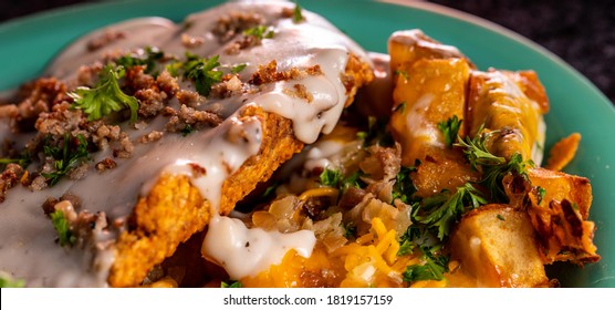 A Crispy Chicken Fried Steak With Cheesy Potatoes, Eggs And Gravy.