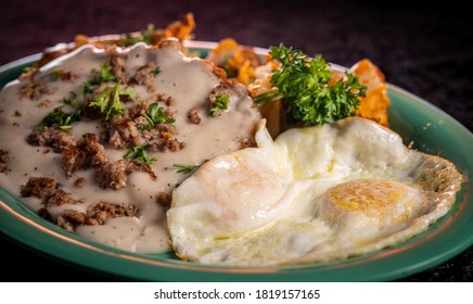 A Crispy Chicken Fried Steak With Cheesy Potatoes, Eggs And Gravy.