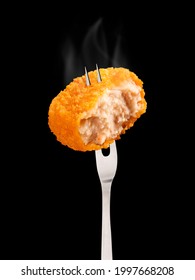 Crispy Chicken Nugget On Fork Against With Smoke On A Black Background.