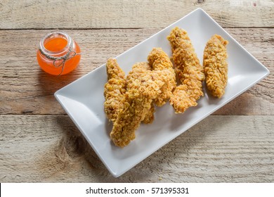 Crispy Chicken Strips On Weathered Wood Table With Texture