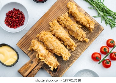Crispy chicken tenders cuts on white background, top view. - Shutterstock ID 1977017618