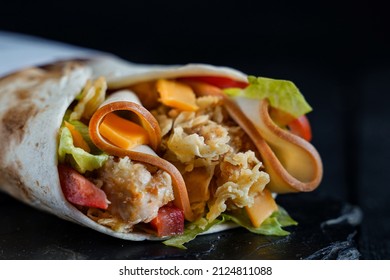 Crispy Chicken Tortilla Wrap With Turkey Bacon On Black Background                