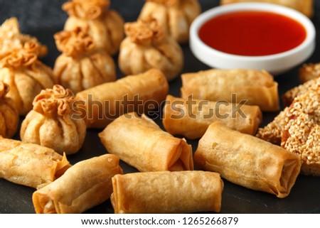 Crispy Chicken wontons, vegetable spring rolls and prawn toasts with sweet chilli sauce. chinese selection. fast food.